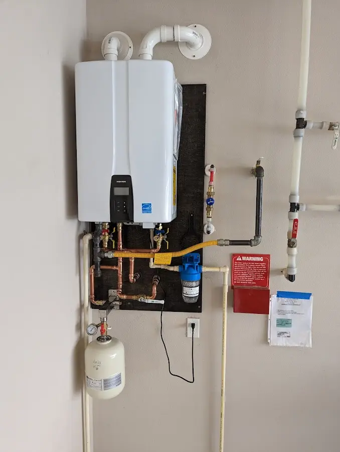 Professional plumber installing copper piping in a Sebastian home